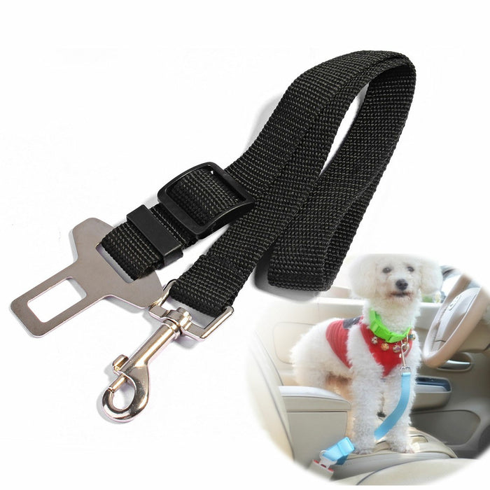 Adjustable black nylon dog safety seat belt with metal clip, shown beside a dog secured in a car seat.