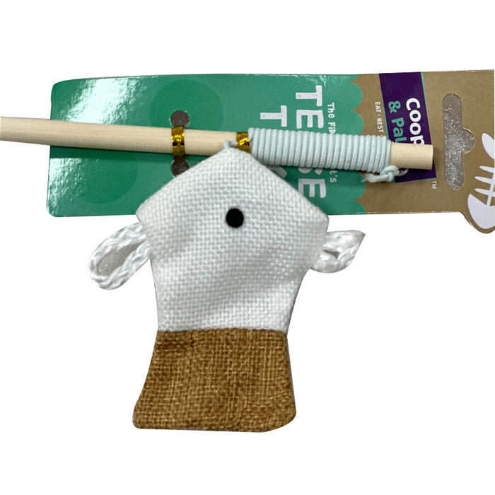 A white and brown cotton cat toy shaped like a house attached to a wooden rod with a colorful string.