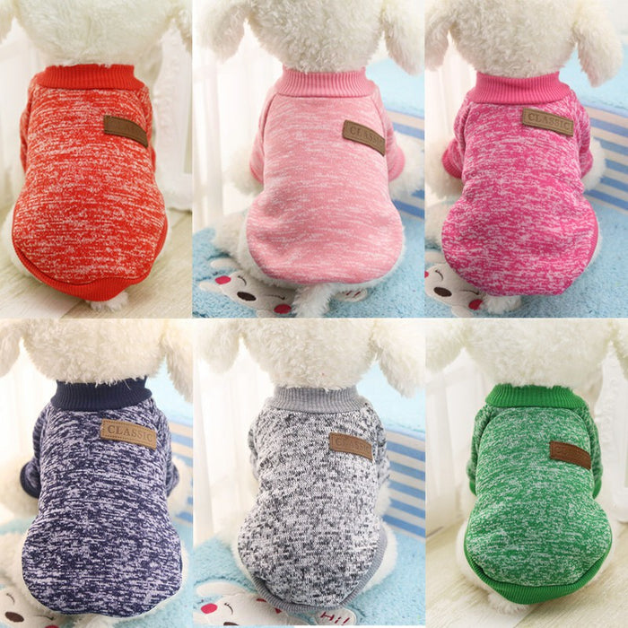 Cozy knitted dog jackets in six colors: red, pink, purple, gray, white, and green, displayed on a soft, plush surface.