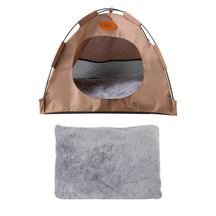 A brown pet tent with a mesh opening and a soft gray bed pad positioned below for comfort.