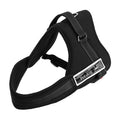 Adjustable black dog harness made of durable material, featuring a padded design and metal D-ring for leash attachment.