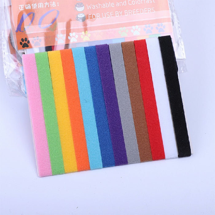 A variety of colorful felt ID collars for puppies and kittens displayed in a neat row on a light background.