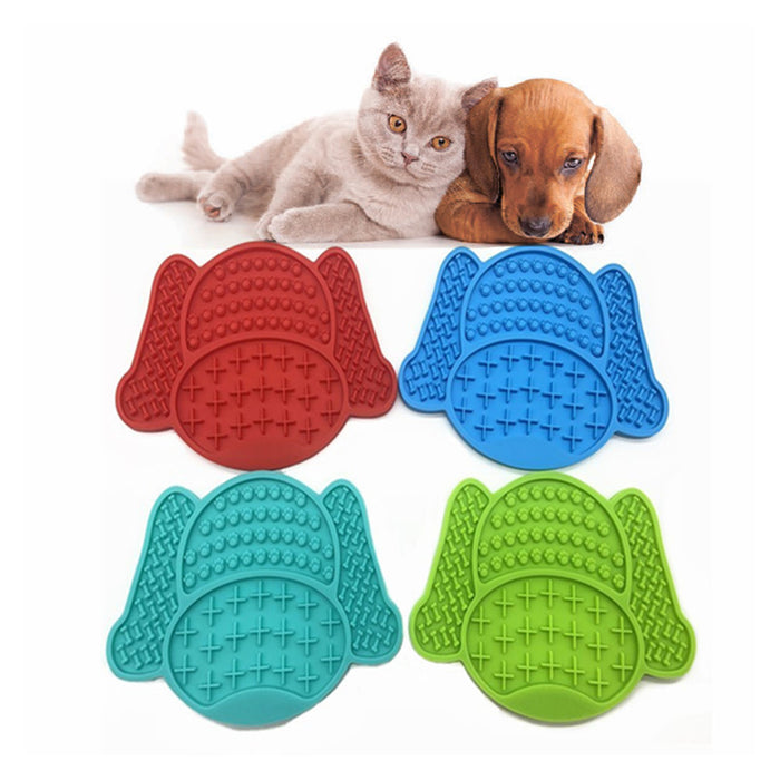 Four colorful non-slip silicone dog lick pads in red, blue, turquoise, and green, shaped like playful dog heads.