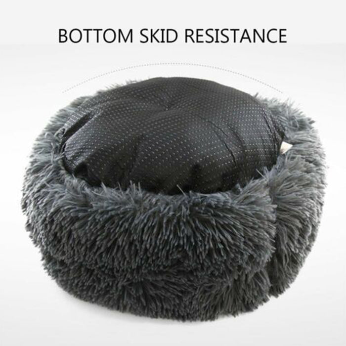Round pet bed featuring a cushioned black center and plush gray faux fur outer, designed for comfort and skid resistance.
