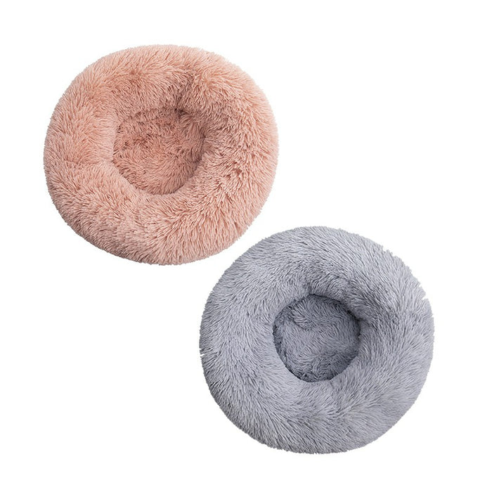 Two round, fluffy pet beds in soft pink and gray colors, featuring a cozy, plush texture for ultimate comfort.