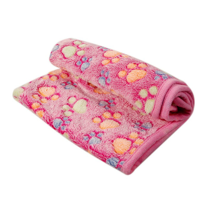 Soft pink pet mat featuring colorful paw prints and a plush texture, neatly rolled and showcasing its cozy design.